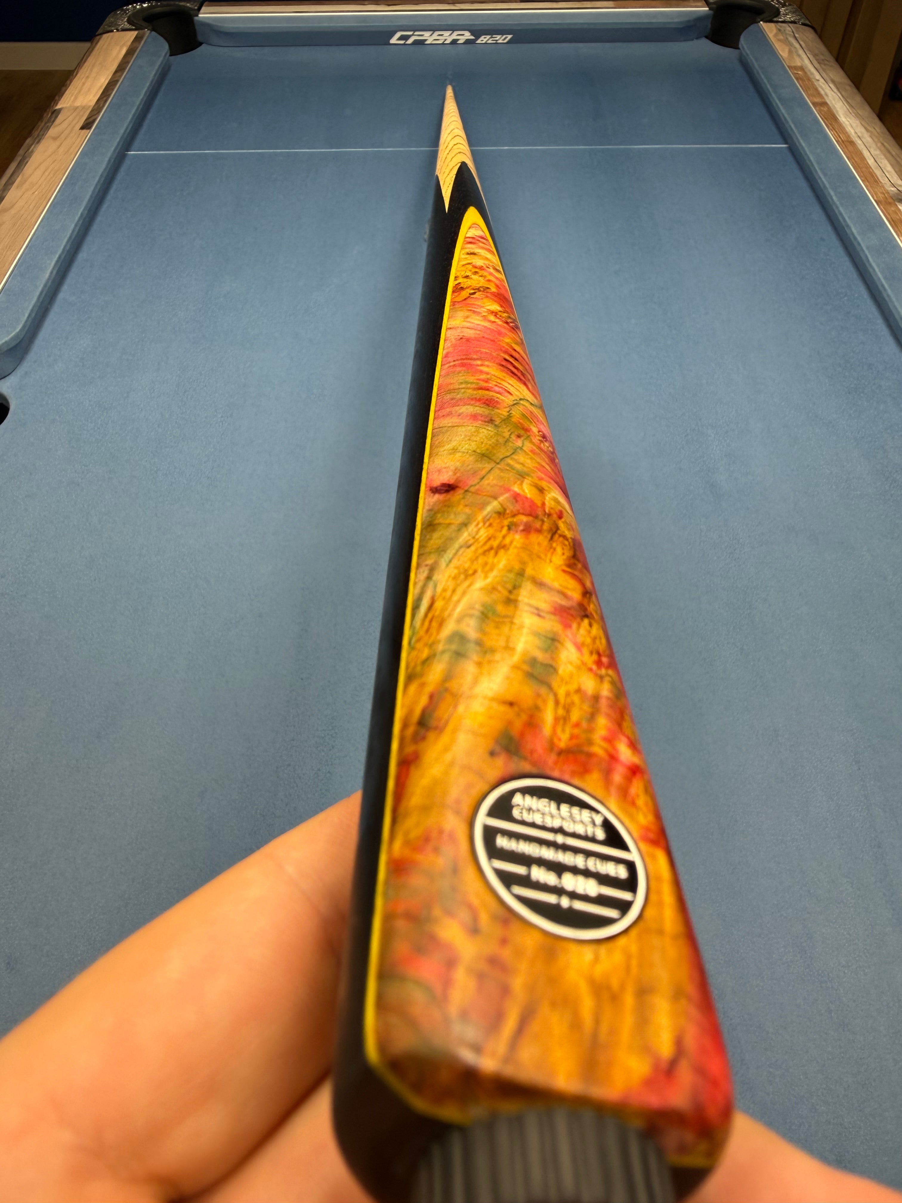 Anglesey Cuesports Crimson Burr Cue No.026 - hand-held butt view showing No.026 badge and crimson burr grain